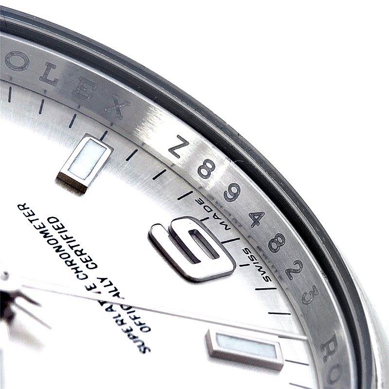This close-up image shows the dial and part of the rehaut of a Rolex Air-King 114200 Men's Stainless Steel Silver Dial 114200 Men's Stainless Steel Silver Dial watch, featuring numbers and text.