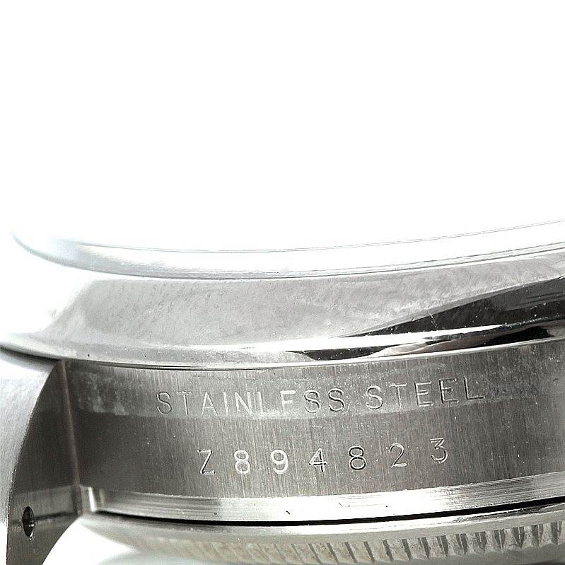 The image shows a close-up of the stainless steel body and the engraved serial number of the Rolex Air-King 114200 Men's Stainless Steel Silver Dial 114200 Men's Stainless Steel Silver Dial watch.