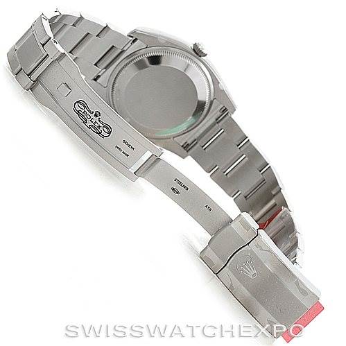 The image shows the underside of the Rolex Air-King 114200 Men's Stainless Steel Silver Dial 114200 Men's Stainless Steel Silver Dial watch, highlighting its open clasp and bracelet, with the case back partially visible.