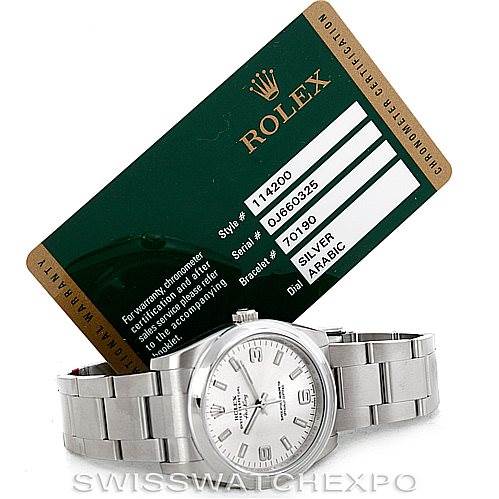 The image shows a Rolex Air-King 114200 Men's Stainless Steel Silver Dial 114200 Men's Stainless Steel Silver Dial watch lying flat with its certification card displayed in the background.