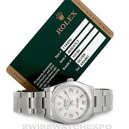 The Rolex Air-King 114200 Men's Stainless Steel Silver Dial 114200 Men's Stainless Steel Silver Dial watch is shown from the front, along with its watch bracelet and authenticity card.