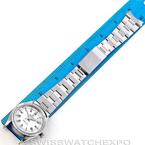 The Rolex Air-King 14010 Men's Stainless Steel White Dial 14010 Men's Stainless Steel White Dial watch is shown from an overhead angle, displaying its face, bracelet, and clasp next to a blue measuring ruler.