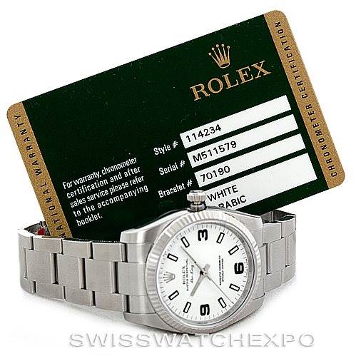 The image shows a Rolex Air-King 114234 Men's Stainless Steel White Dial 114234 Men's Stainless Steel White Dial watch from an oblique angle, along with its warranty card displaying model details.