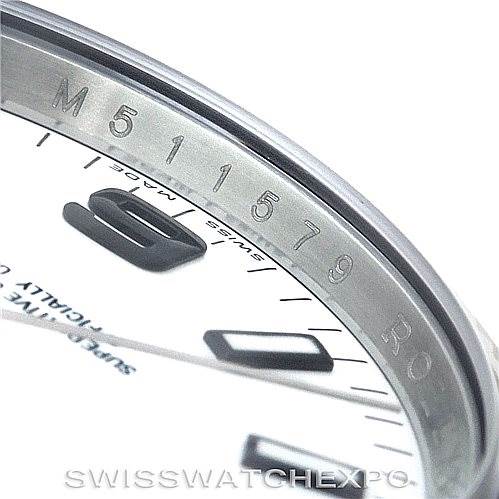 This close-up shows the bezel and part of the dial of a Rolex Air-King 114234 Men's Stainless Steel White Dial 114234 Men's Stainless Steel White Dial watch, highlighting the serial number engraving and some hour markers.