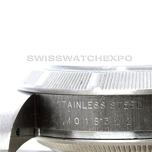 This image shows a close-up of the side profile of a Rolex Air-King 114210 Men's Stainless Steel Silver Dial 114210 Men's Stainless Steel Silver Dial watch, highlighting the "Stainless steel" inscription and part of the case back.