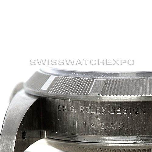 This image shows a close-up side view of the Rolex Air-King 114210 Men's Stainless Steel Silver Dial 114210 Men's Stainless Steel Silver Dial case, displaying the model and engraving "ORIG. ROLEX DESIGN 114210."