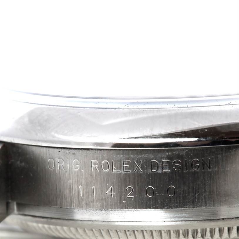 The image shows a close-up of the case side and bezel for the Rolex Air-King 114200 Men's Stainless Steel Silver Dial 114200 Men's Stainless Steel Silver Dial watch, displaying the model number 114200 and "ORIG. ROLEX DESIGN."