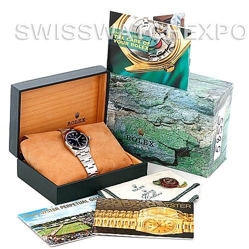 The image shows a Rolex Air-King 14000 Men's Stainless Steel Black Dial 14000 Men's Stainless Steel Black Dial watch in its box along with its accessories, including manuals and other documents.