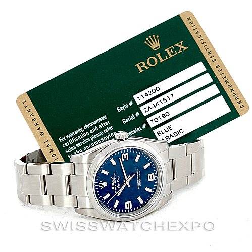 This image shows a Rolex Air-King 114200 Men's Stainless Steel Blue Dial 114200 Men's Stainless Steel Blue Dial watch placed in front of its certification card.