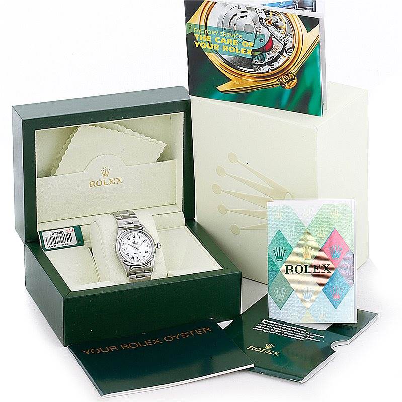 The image shows a Rolex Air-King 14000 Men's Stainless Steel White Dial 14000 Men's Stainless Steel White Dial watch in its box, surrounded by accompanying manuals and a cleaning cloth.