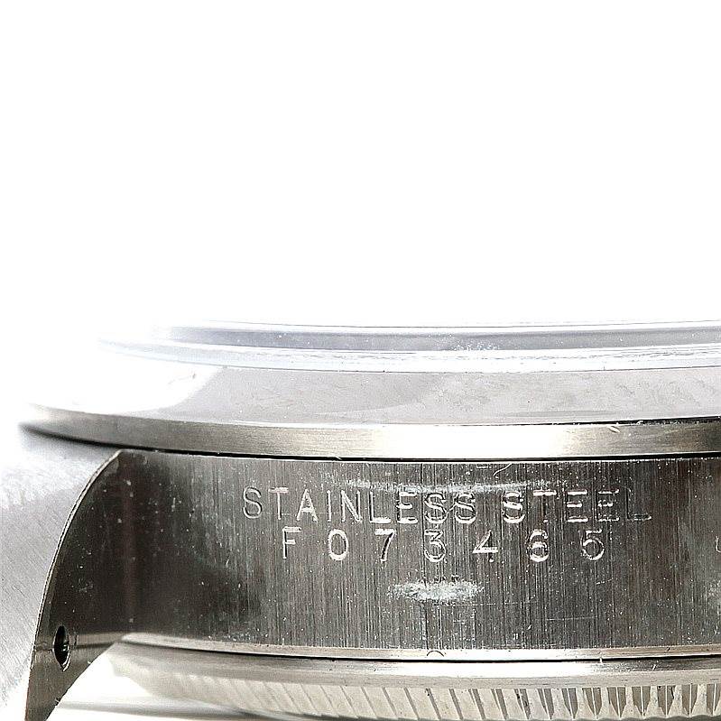 This image shows a close-up side angle of the casing and serial number of a Rolex Air-King 14000 Men's Stainless Steel White Dial 14000 Men's Stainless Steel White Dial watch.