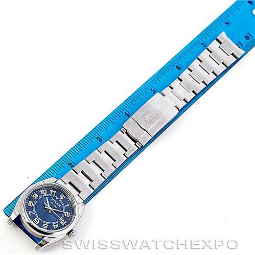 The image shows a Rolex Air-King 114200 Men's Stainless Steel Blue Dial 114200 Men's Stainless Steel Blue Dial watch laid flat, showcasing the face, bracelet, and clasp, next to a blue ruler for scale.