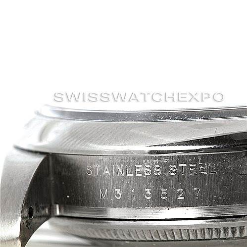 This image shows a close-up of the case side of the Rolex Air-King 114200 Men's Stainless Steel Blue Dial 114200 Men's Stainless Steel Blue Dial watch, highlighting the engraving "STAINLESS STEEL M313527."