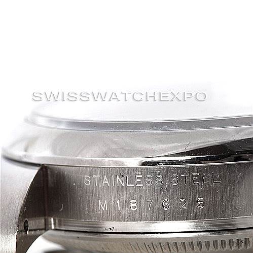 The image shows a close-up of the case side of a Rolex Air-King 114200 Men's Stainless Steel Blue Dial 114200 Men's Stainless Steel Blue Dial watch, highlighting the stainless steel material and serial number engraving.