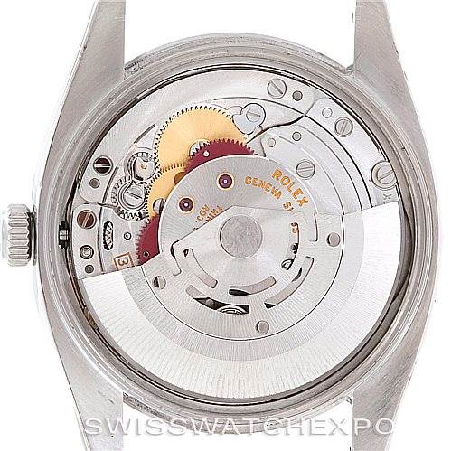 The image shows the back view of a Rolex Air-King 114200 Men's Stainless Steel Blue Dial 114200 Men's Stainless Steel Blue Dial watch with its internal mechanical movement visible.