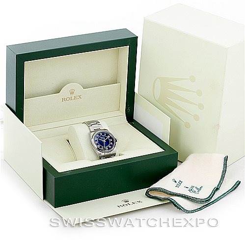 The Rolex Air-King 114200 Men's Stainless Steel Blue Dial 114200 Men's Stainless Steel Blue Dial watch is displayed inside its open packaging box, shown at a slight angle with a cleaning cloth included.