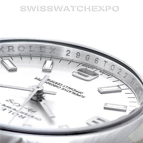This image shows a close-up angle of a Rolex Air-King 114200 Men's Stainless Steel Silver Dial 114200 Men's Stainless Steel Silver Dial watch face and bezel, highlighting the minute markers and some engraved details.
