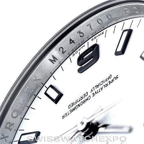 The image shows a close-up of the Rolex Air-King 114210 Men's Stainless Steel White Dial 114210 Men's Stainless Steel White Dial model's dial, focusing on the bezel, part of the hour markers, and the hands.