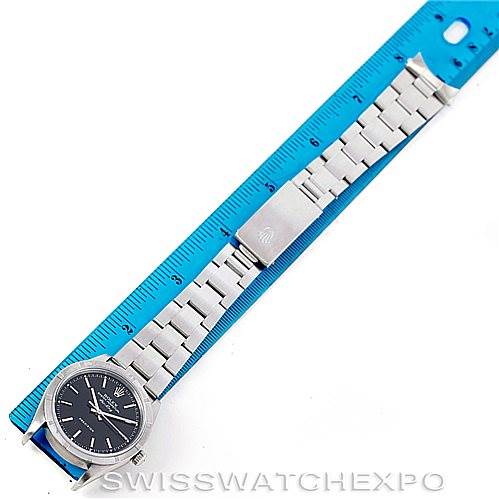 The image shows a Rolex Air-King 14010 Men's Stainless Steel Black Dial 14010 Men's Stainless Steel Black Dial watch laid flat next to a blue ruler, highlighting the face, bracelet, and clasp.