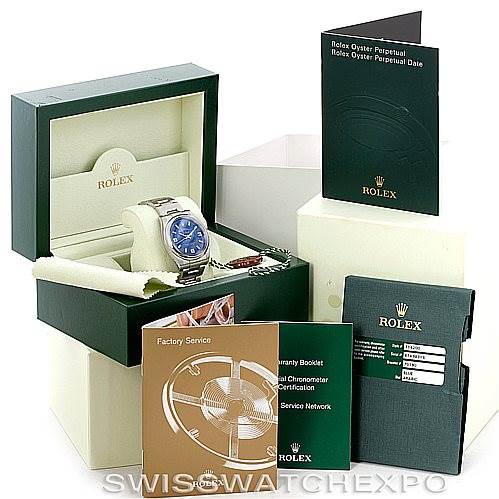 The image shows a Rolex Air-King 114200 Men's Stainless Steel Blue Dial 114200 Men's Stainless Steel Blue Dial watch with its original packaging, booklets, and certification documents displayed at an angle.