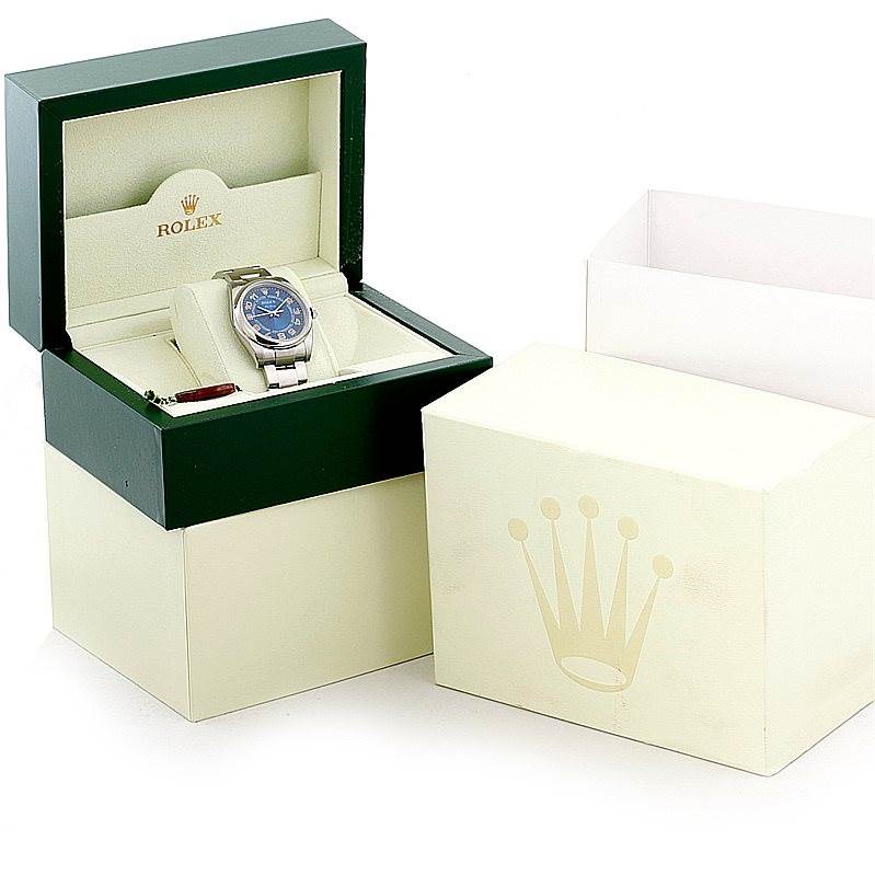 The photo shows a Rolex Air-King 114200 Men's Stainless Steel Blue Dial 114200 Men's Stainless Steel Blue Dial watch in an open display box, with the outer packaging also visible.