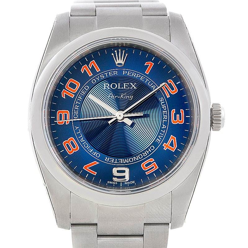 The image shows a front view of the Rolex Air-King 114200 Men's Stainless Steel Blue Dial 114200 Men's Stainless Steel Blue Dial watch, featuring a blue dial with orange numerals, silver hands, and a stainless steel band.