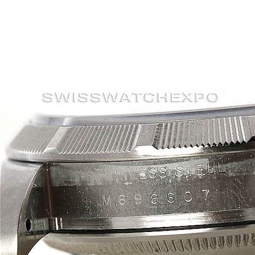 This is a close-up side view of the bezel and case of a Rolex Air-King 114210 Men's Stainless Steel White Dial 114210 Men's Stainless Steel White Dial watch, showing the engraved text and stainless steel material.