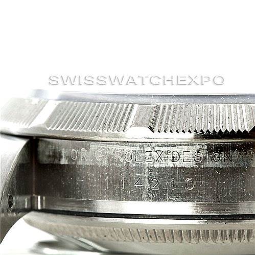This close-up image of the Rolex Air-King 114210 Men's Stainless Steel White Dial 114210 Men's Stainless Steel White Dial watch shows the engraved side of the case and part of the bezel from a side angle.