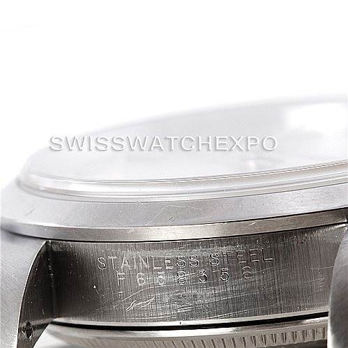 This image shows a close-up of the case side of a Rolex Air-King 14000 Men's Stainless Steel Silver Dial 14000 Men's Stainless Steel Silver Dial watch, highlighting the serial number and "Stainless Steel" engraving.
