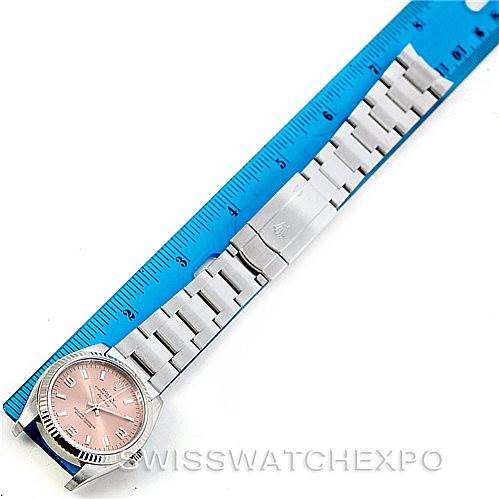 The image shows an overhead view of a Rolex Air-King 114234 Men's Stainless Steel Pink Dial 114234 Men's Stainless Steel Pink Dial watch laid flat next to a blue ruler, emphasizing its length and bracelet.