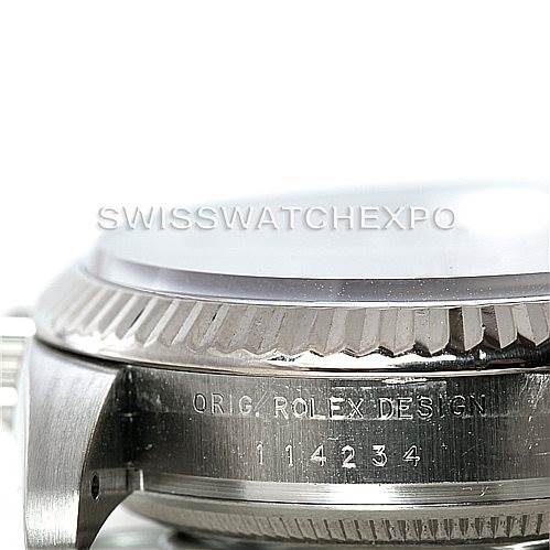 This image shows a close-up of the case side of a Rolex Air-King 114234 Men's Stainless Steel Pink Dial 114234 Men's Stainless Steel Pink Dial watch, highlighting the engraved serial number and "ORIG. ROLEX DESIGN" text.