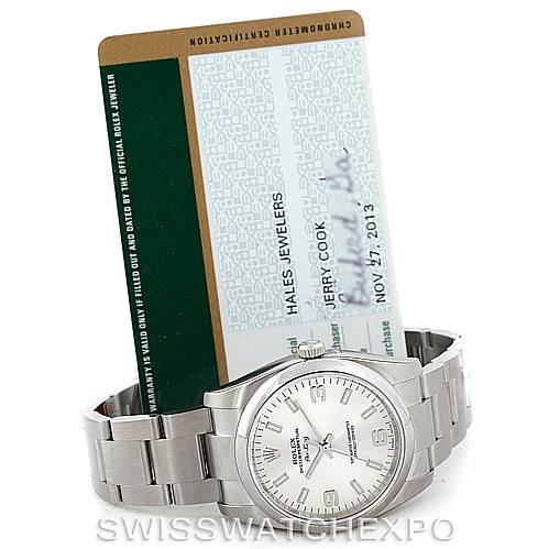 The image shows a Rolex Air-King 114200 Men's Stainless Steel Silver Dial 114200 Men's Stainless Steel Silver Dial watch in a front-facing angle along with a certification card behind it.