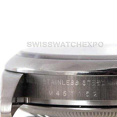 This image shows a close-up view of the side of a Rolex Air-King 114200 Men's Stainless Steel Blue Dial 114200 Men's Stainless Steel Blue Dial watch case, displaying the "stainless steel" engraving and part of the serial number.