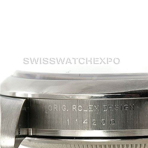 The image shows a close-up side view of the Rolex Air-King 114200 Men's Stainless Steel Blue Dial 114200 Men's Stainless Steel Blue Dial watch case, focusing on the engraved model number and "ORIG. ROLEX DESIGN."