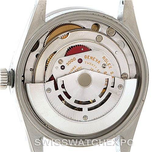 This image shows a detailed view of the movement inside a Rolex Air-King 14010 Men's Stainless Steel Blue Dial 14010 Men's Stainless Steel Blue Dial watch from the back angle, highlighting the rotor and gears.