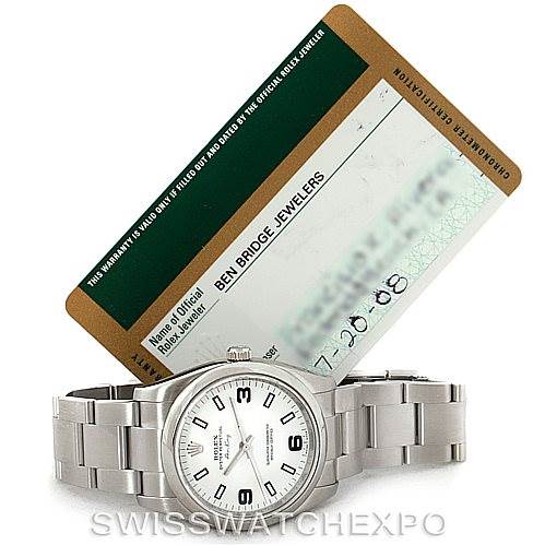 The image shows a Rolex Air-King 114200 Men's Stainless Steel White Dial 114200 Men's Stainless Steel White Dial watch from a front view, accompanied by its warranty card partially placed behind the watch.