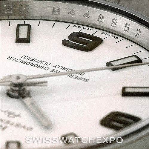 Close-up of a Rolex Air-King 114200 Men's Stainless Steel White Dial 114200 Men's Stainless Steel White Dial watch face, showing the hands, dial, and part of the bezel with serial numbers.