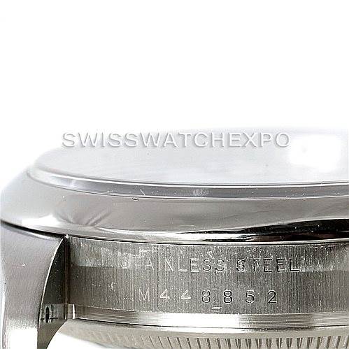 The image shows a close-up, side view of the stainless steel case of a Rolex Air-King 114200 Men's Stainless Steel White Dial 114200 Men's Stainless Steel White Dial watch, focusing on the engraved serial number.