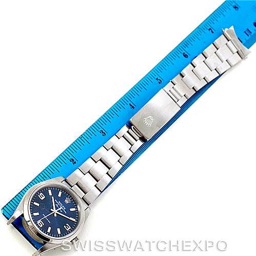 The image shows a top-down view of a Rolex Air-King 14000 Men's Stainless Steel Blue Dial 14000 Men's Stainless Steel Blue Dial watch with its bracelet fully extended next to a blue ruler.