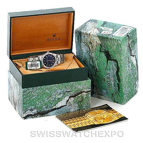 The image shows the Rolex Air-King 14010 Men's Stainless Steel Blue Dial 14010 Men's Stainless Steel Blue Dial watch at an angled view, inside its open box, with outer box packaging and a booklet beside it.