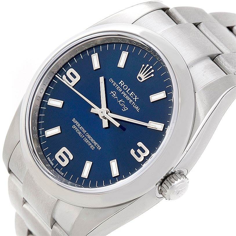 The image shows a close-up view of a Rolex Air-King 114200 Men's Stainless Steel Blue Dial 114200 Men's Stainless Steel Blue Dial watch from an angle that highlights the dial and part of the bracelet.