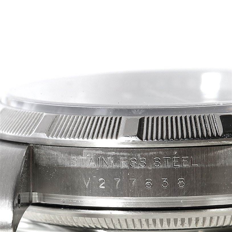 Close-up of the Rolex Air-King 114210 Men's Stainless Steel Blue Dial 114210 Men's Stainless Steel Blue Dial watch's side, showcasing the stainless steel case and bezel with a clear view of the serial number.