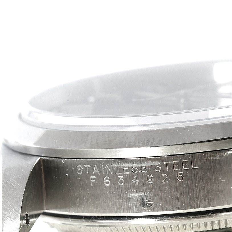 The image shows a close-up angle of the side of a Rolex Air-King 14000 Men's Stainless Steel Black Dial 14000 Men's Stainless Steel Black Dial watch case, highlighting its stainless steel material and serial number.