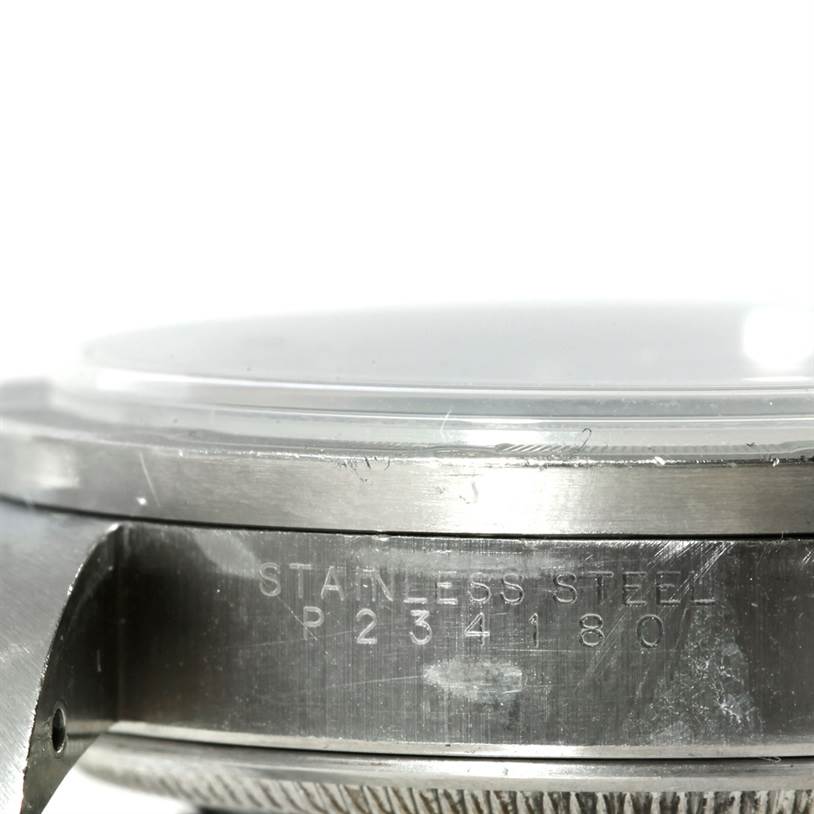 The image shows a close-up side angle of the stainless steel case back and crystal of a Rolex Air-King 14010 Men's Stainless Steel Blue Dial 14010 Men's Stainless Steel Blue Dial watch.