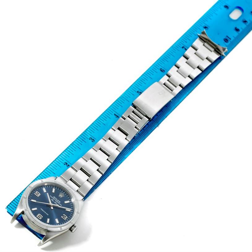 The Rolex Air-King 14010 Men's Stainless Steel Blue Dial 14010 Men's Stainless Steel Blue Dial watch is shown fully extended with its bracelet alongside a ruler for measurement.