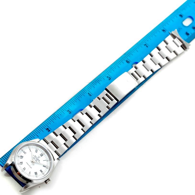 The image shows a Rolex Air-King 14000 Men's Stainless Steel White Dial 14000 Men's Stainless Steel White Dial watch placed alongside a blue ruler, showcasing its face, bracelet, and clasp.