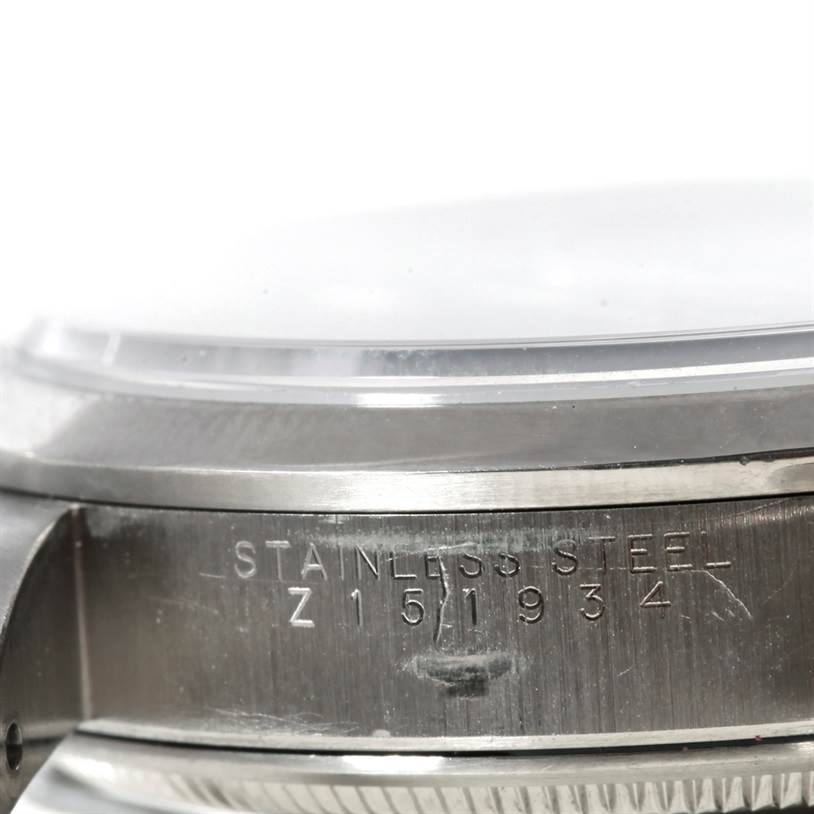The image shows a close-up side view of the Rolex Air-King 14000 Men's Stainless Steel Blue Dial 14000 Men's Stainless Steel Blue Dial watch case, highlighting the stainless steel engraving and the serial number.