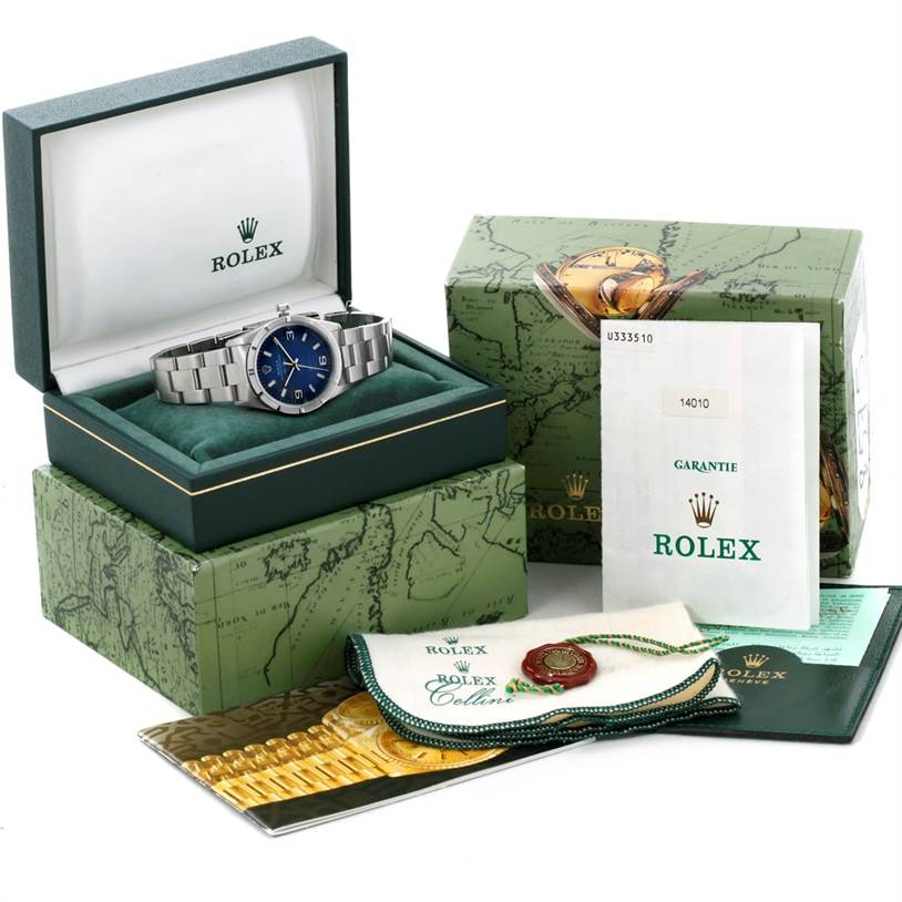 The image shows a Rolex Air-King 14010 Men's Stainless Steel Blue Dial 14010 Men's Stainless Steel Blue Dial watch in its box, accompanied by a warranty booklet, outer box, and additional accessories.