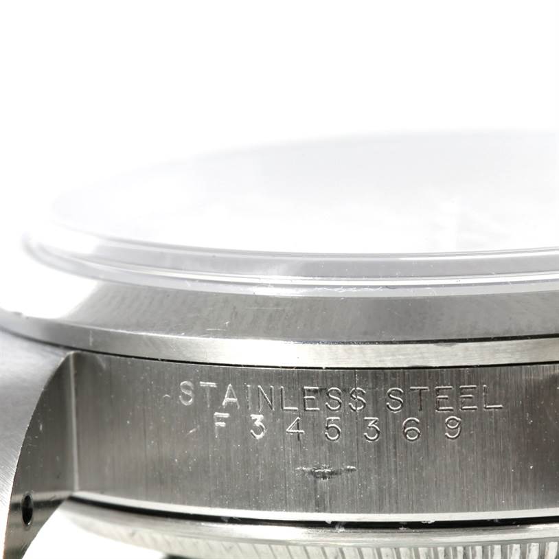 The image shows a close-up side view of a Rolex Air-King 14000 Men's Stainless Steel Silver Dial 14000 Men's Stainless Steel Silver Dial watch highlighting the stainless steel case and engraved serial number.