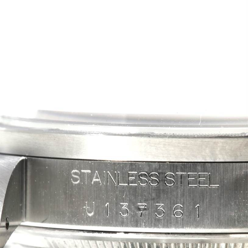 This image shows a close-up of the stainless steel side of a Rolex Air-King 14010 Men's Stainless Steel Pink Dial 14010 Men's Stainless Steel Pink Dial watch, showcasing its engraved serial number.